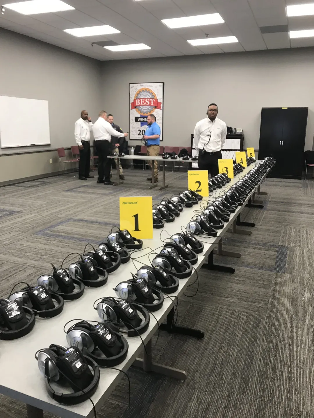 Rental headsets laid out on tables in a meeting room, ready for an event