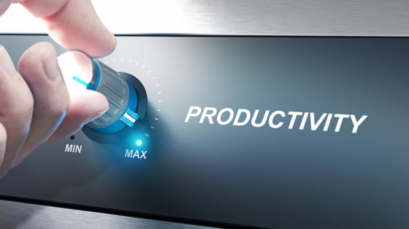 Hand turning a dial labeled Productivity from min toward max