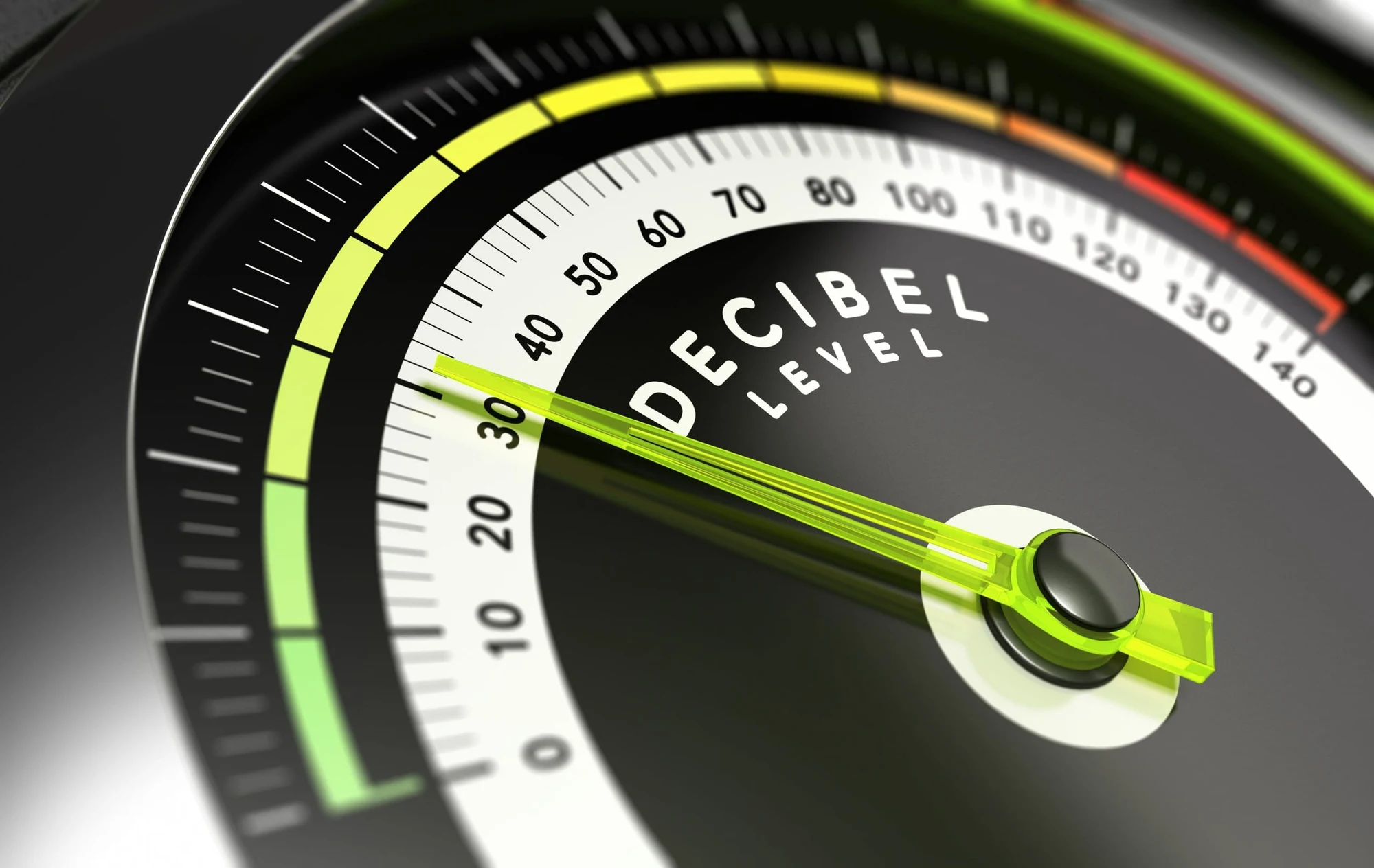 Close-up of a gauge labeled decibel level with the needle pointing to a low reading